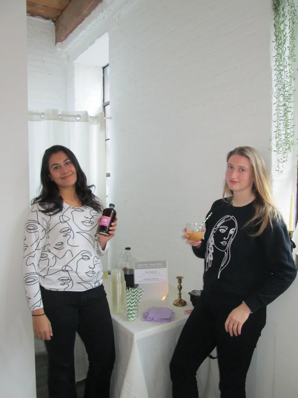 Two friends holding Body Coffee bottles