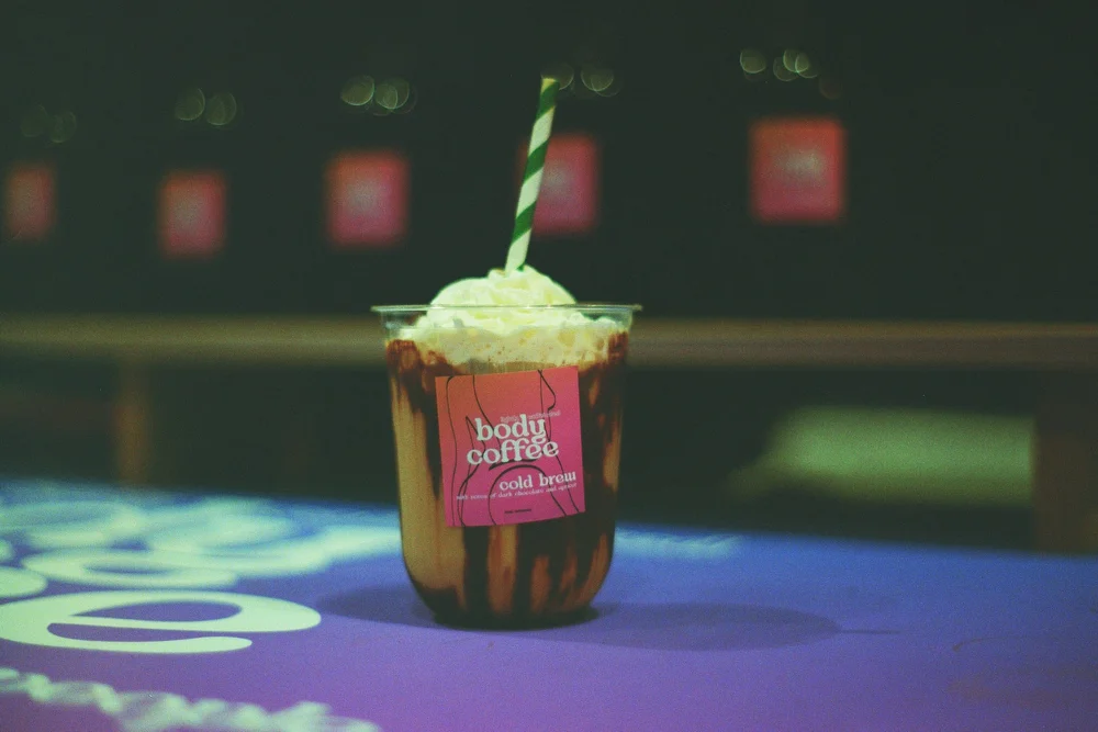 Iced cold brew topped with whipped cream at an event