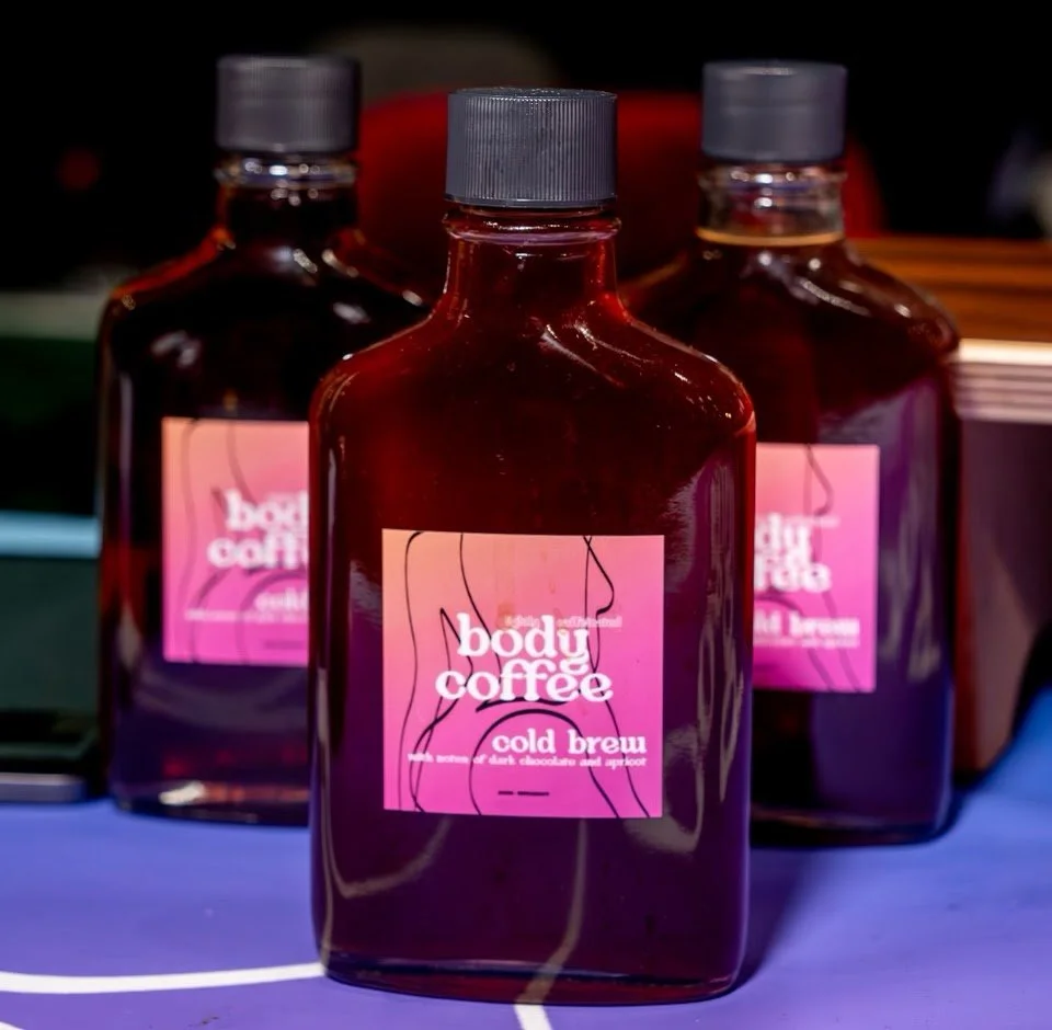Three bottles of cold brew on a purple table